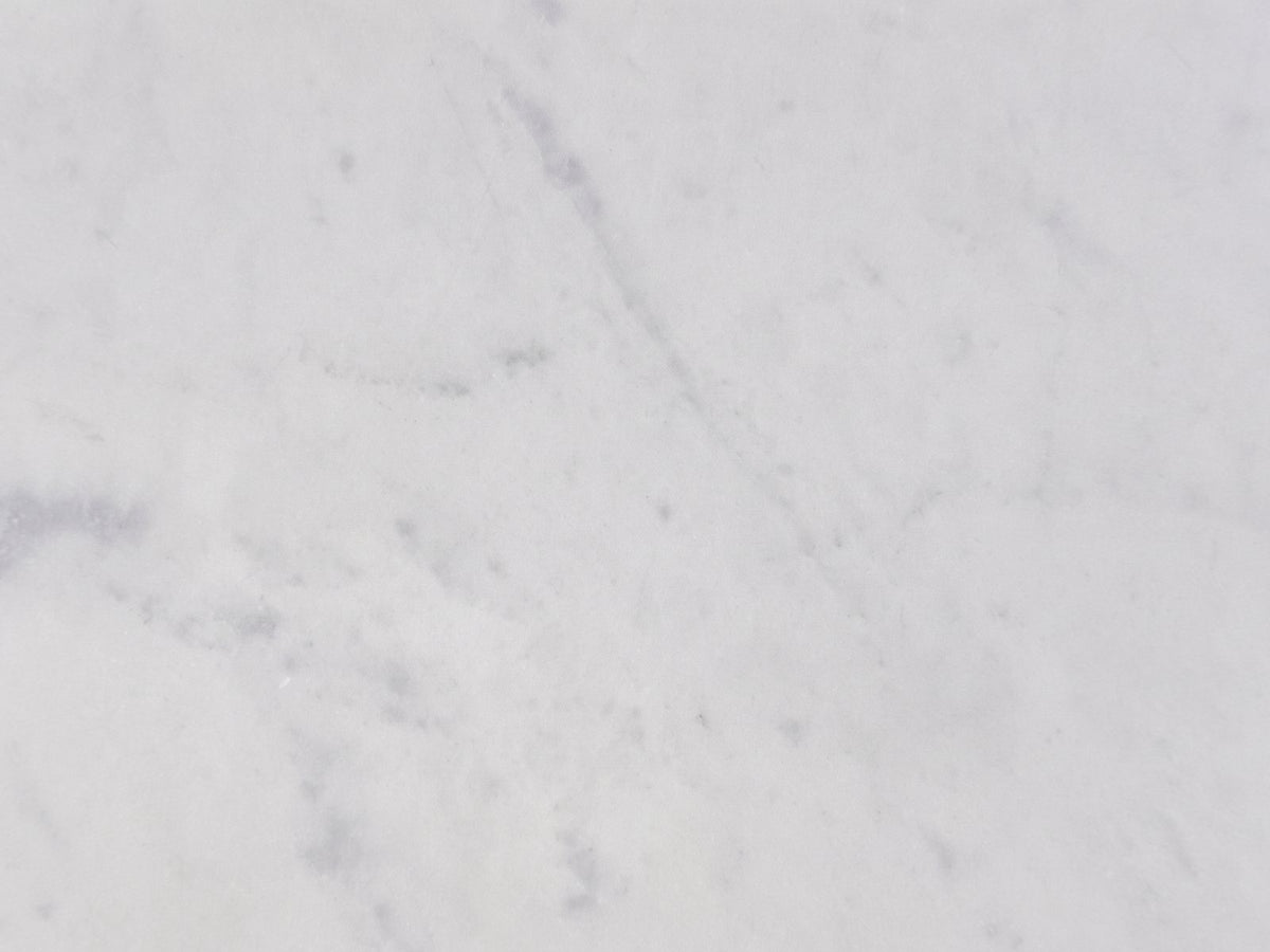 Close-up of the Acerenza White Marble Pedestal Side Table: the white marble top