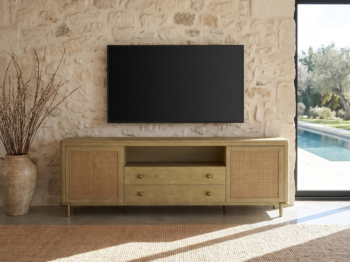 Alassio 80-Inch Sand Wash Ash and Rattan Media Console under a wall-mounted screen on a pale stone wall in a poolside villa