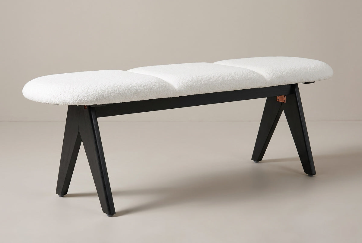 The Alatri bench with a white fabric seat and black legs, three-quarter view on a light studio backdrop