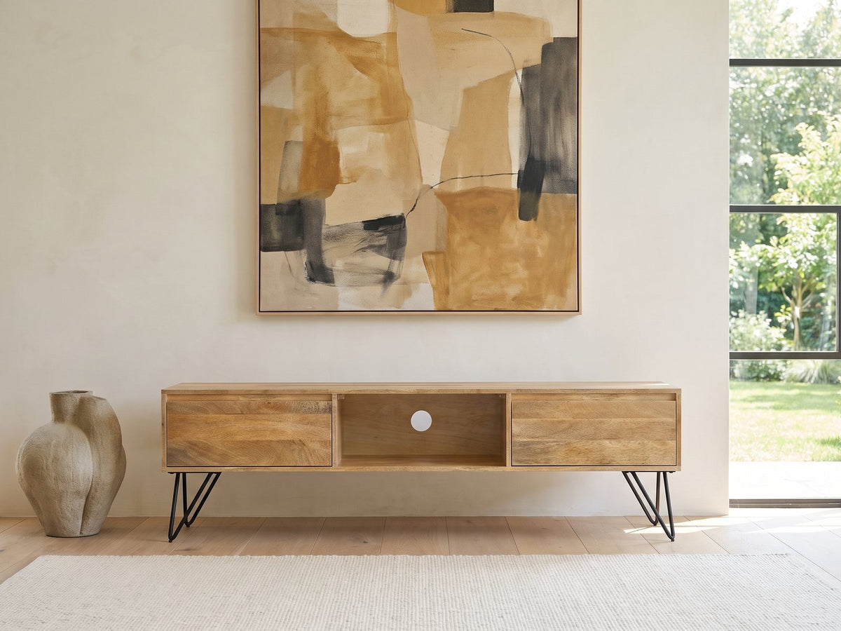 Alberobello Low Mango Media Console under a large abstract painting in a bright living room