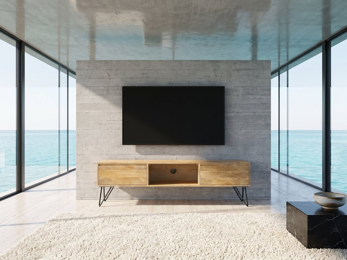 Alberobello Low Mango Media Console under a wall-mounted screen in an oceanfront glass house