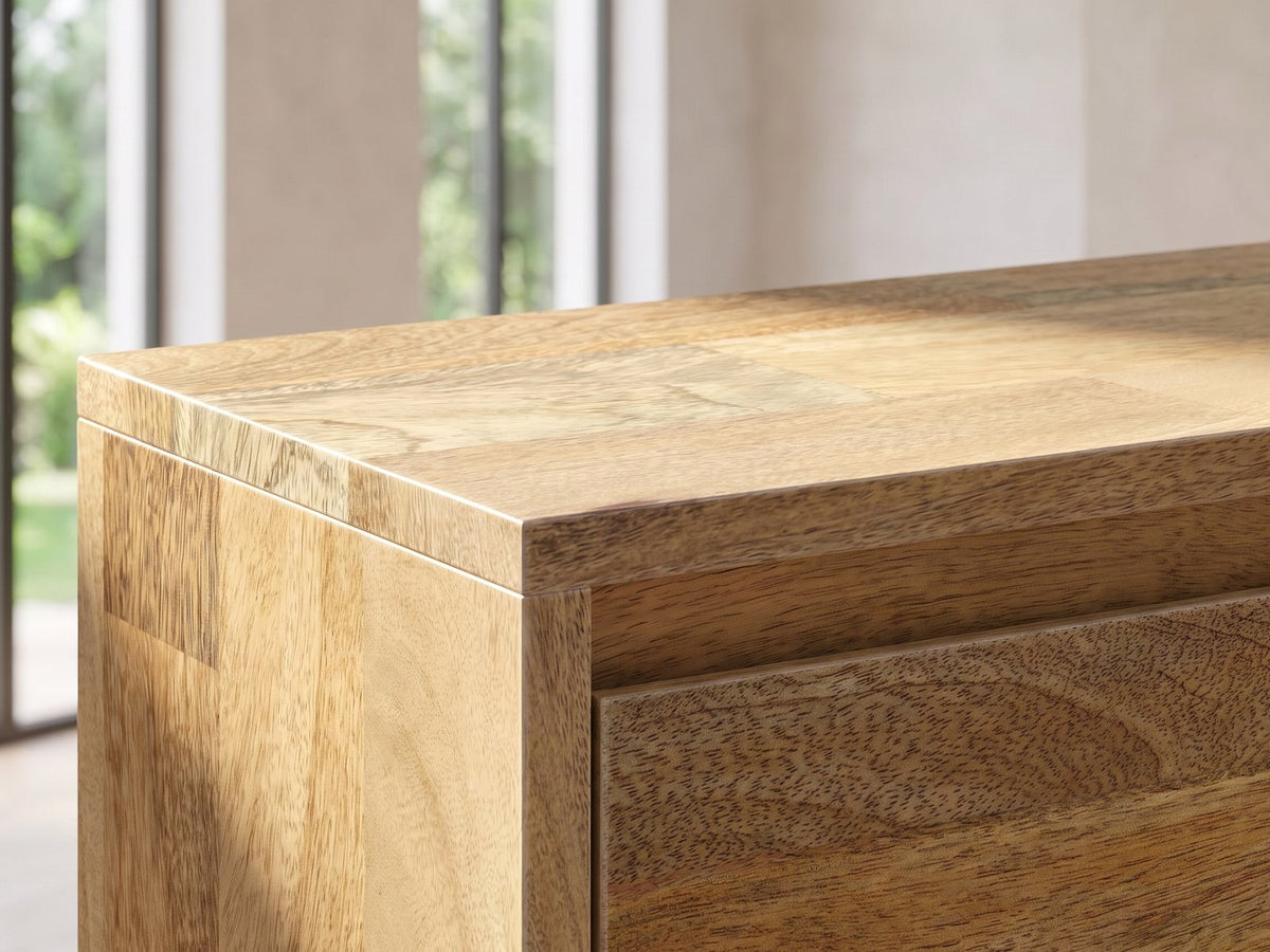 Close-up of the Alberobello Low Mango Media Console: the top corner: the natural mango plank pattern on the top and the door below