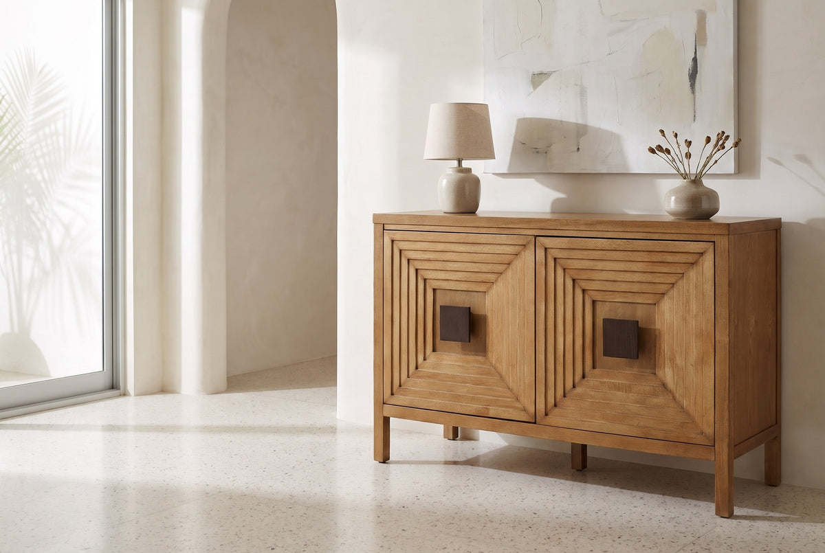 Altamura two-door sideboard with a lamp and a vase on top against a warm-white plaster wall in a Los Angeles living room with a terrazzo floor