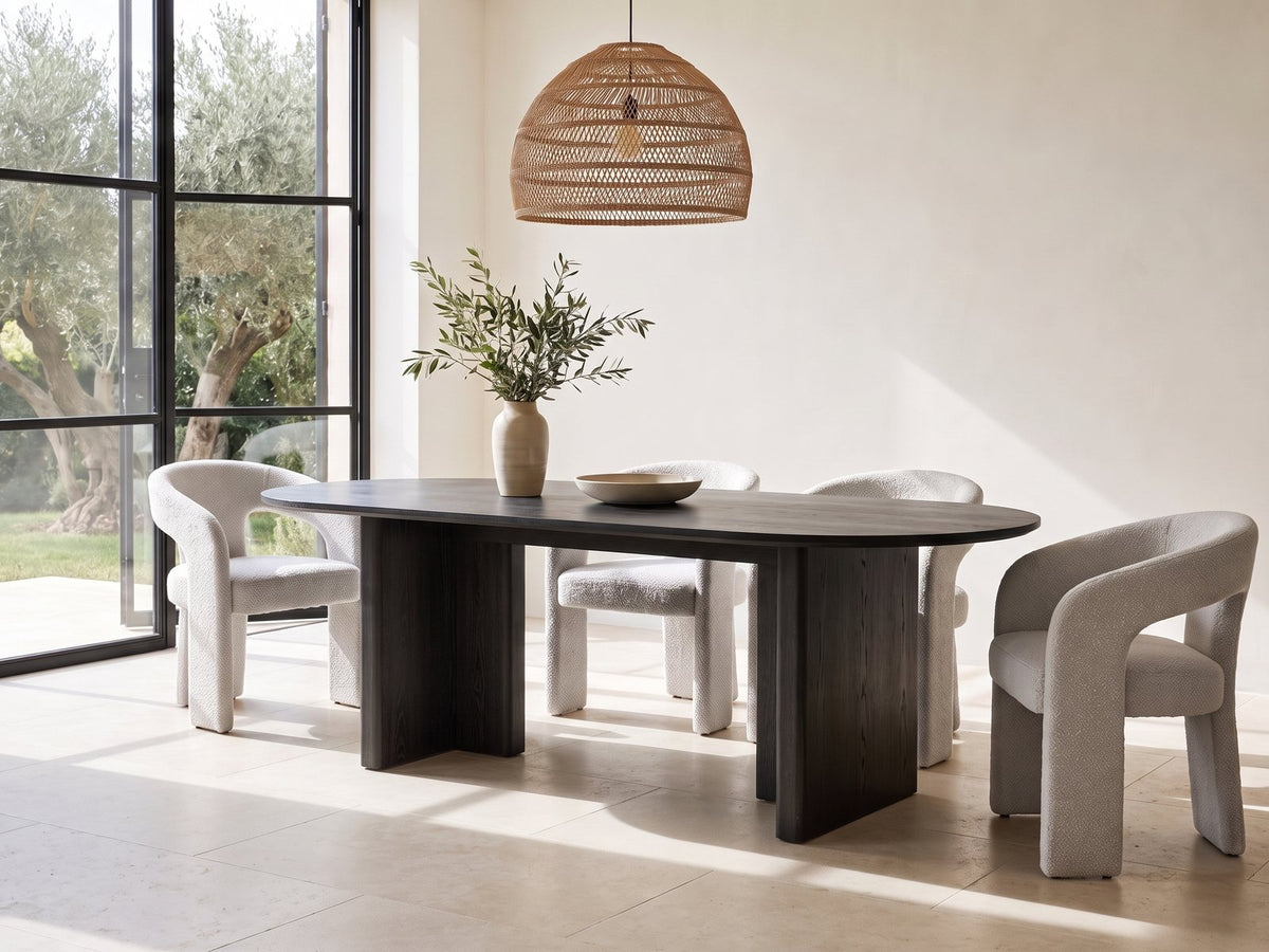 Anticoli 78-Inch Ebony Oak Pedestal Dining Set with 4 Boucle Armchairs in a sunlit villa dining area with olive trees outside