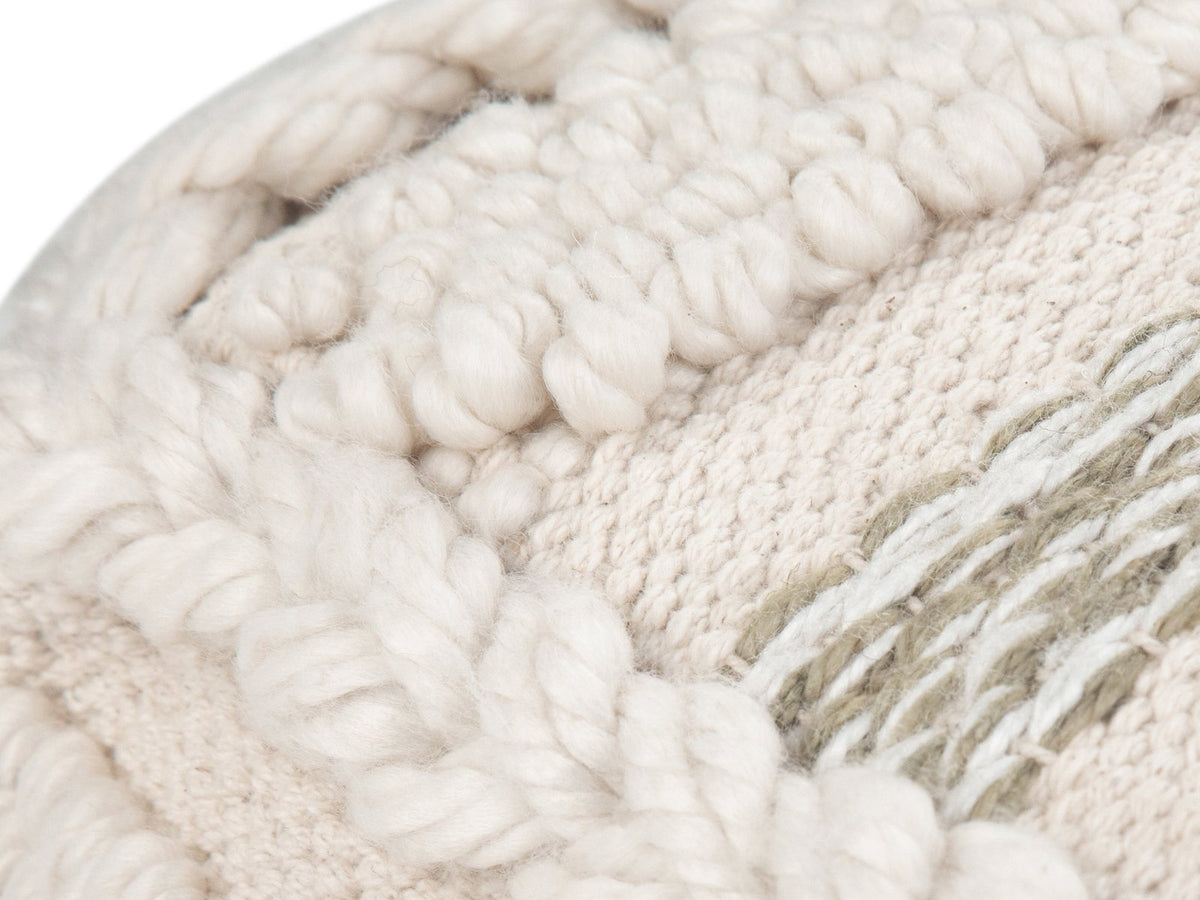 Close-up of the Apricale Natural Handloom Cotton Square Pouf: the handloom cotton weave: braided cord, loop texture and khaki-and-white stripes