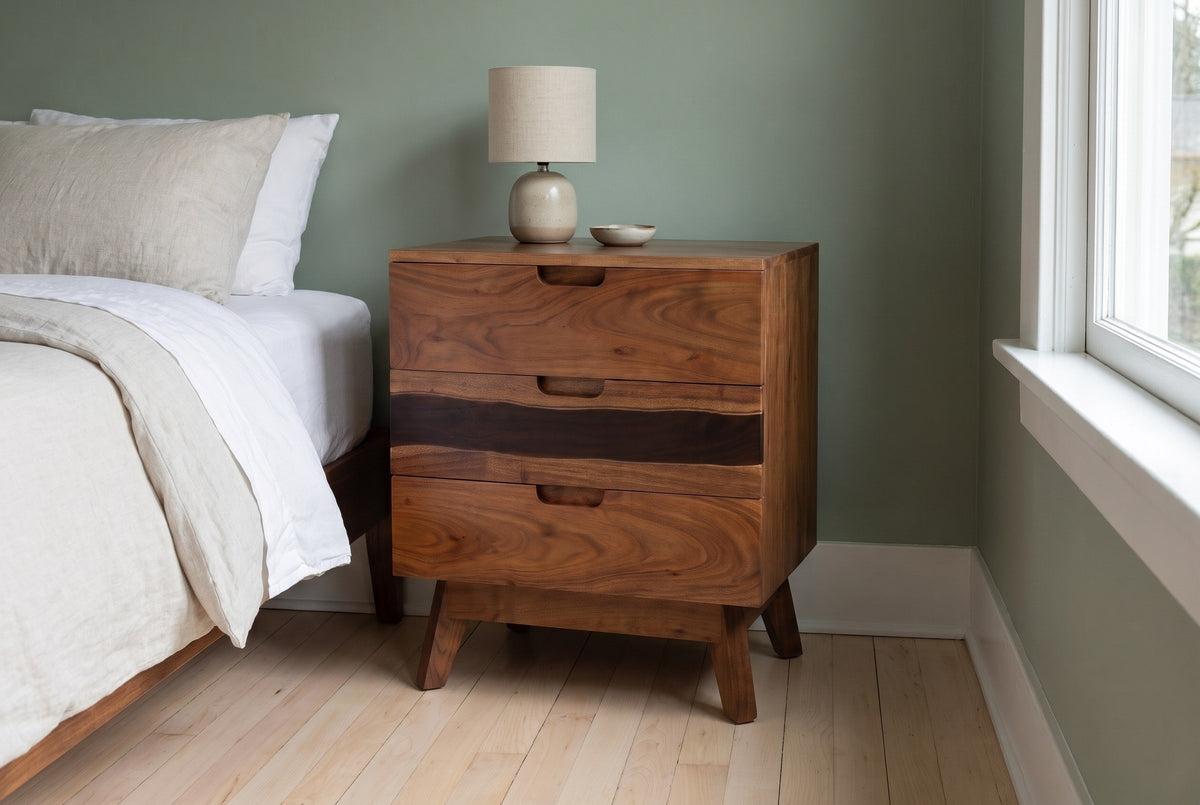 Arborea acacia nightstand with a ceramic lamp in a Portland craftsman bedroom with a sage-green wall and pale maple floors