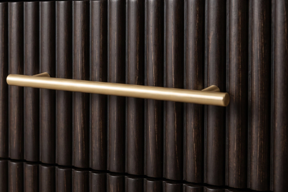 A reeded espresso drawer front of the Aritzo nightstand with its slim gold-finish bar pull standing off the reeds