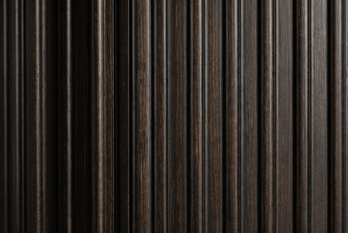 Close-up of the espresso reeds on the Aritzo nightstand: rounded vertical reeds with lighter brown grain and dark grooves between them