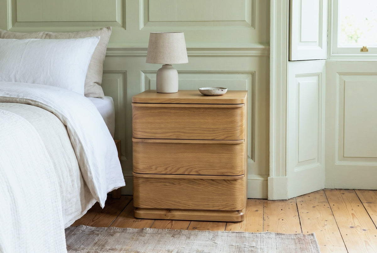 Arzachena oak nightstand against pale pistachio-green panelling in a Savannah townhouse bedroom with heart-pine floors