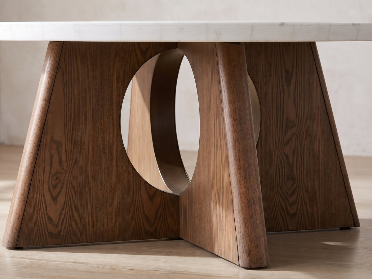 Close-up of the Asti 40-Inch Round White Marble Coffee and End Table Set, 3 Pieces: the brown ash cross base with its round cut-out under the white marble top