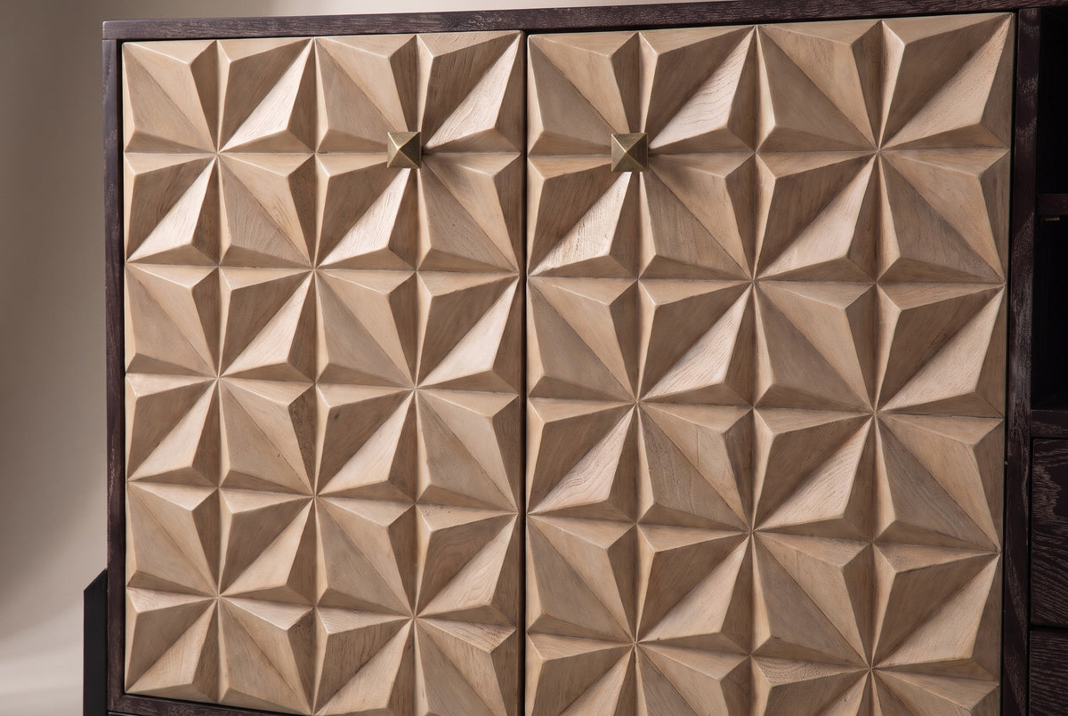 The two carved doors of the Atella sideboard up close: sand-colored square tiles rising to sharp pyramid points, with a small antique-brass pyramid knob near the top of each door