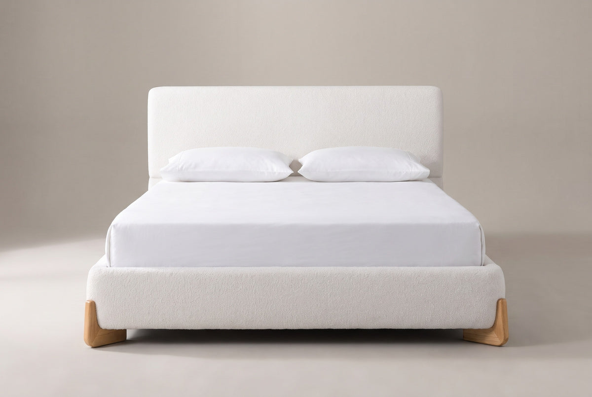 Atessa bed in white boucle with a white mattress and pillows (not included), front view