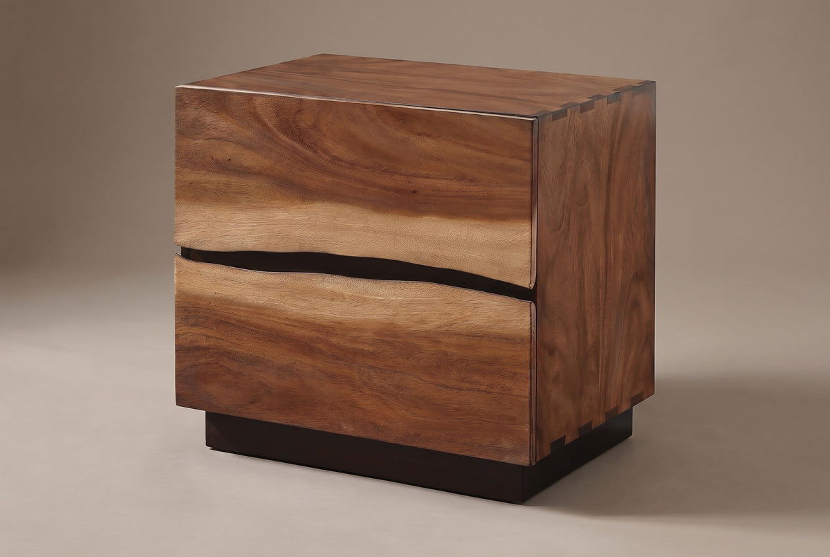 The Barumini two-drawer nightstand in suar and walnut veneer with a wavy gap between the drawers, three-quarter view on a light studio backdrop