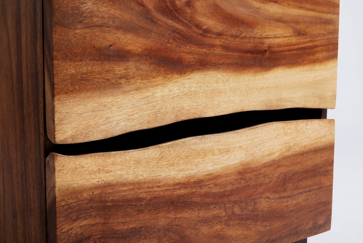 The two drawers of the Barumini nightstand meeting at a wavy edge with a black reveal, pale golden suar above and below