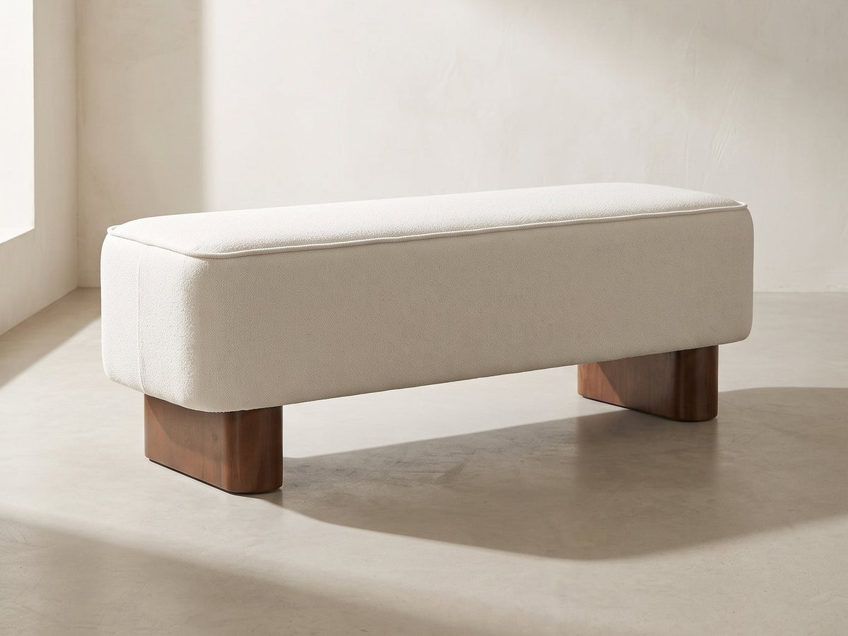 Bellagio Walnut Block Bench in ivory against a plaster wall in morning light