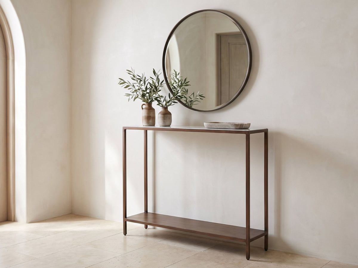 Bellegra White Marble Console Table under a round mirror in a travertine entryway