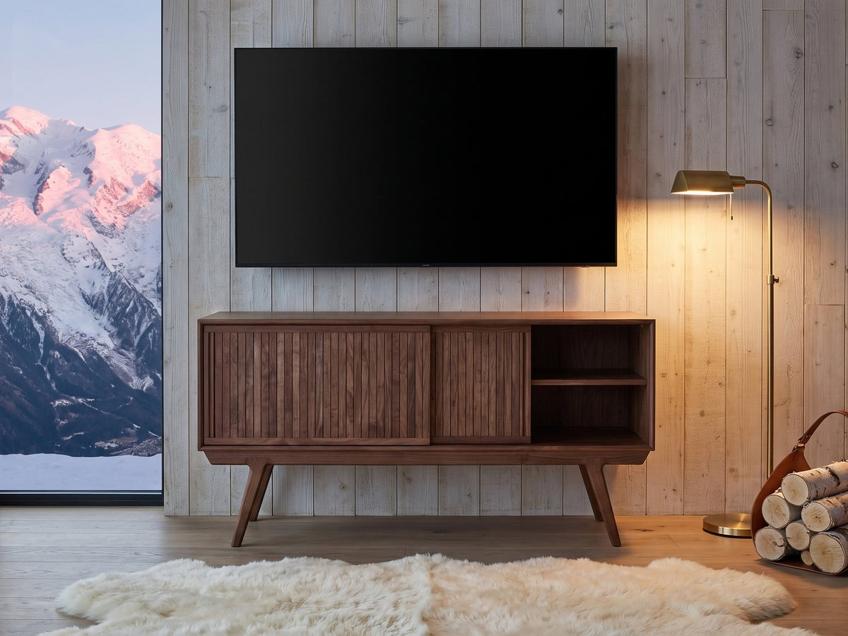 Belluno Solid Walnut Media Cabinet under a wall-mounted screen in an alpine chalet at dusk