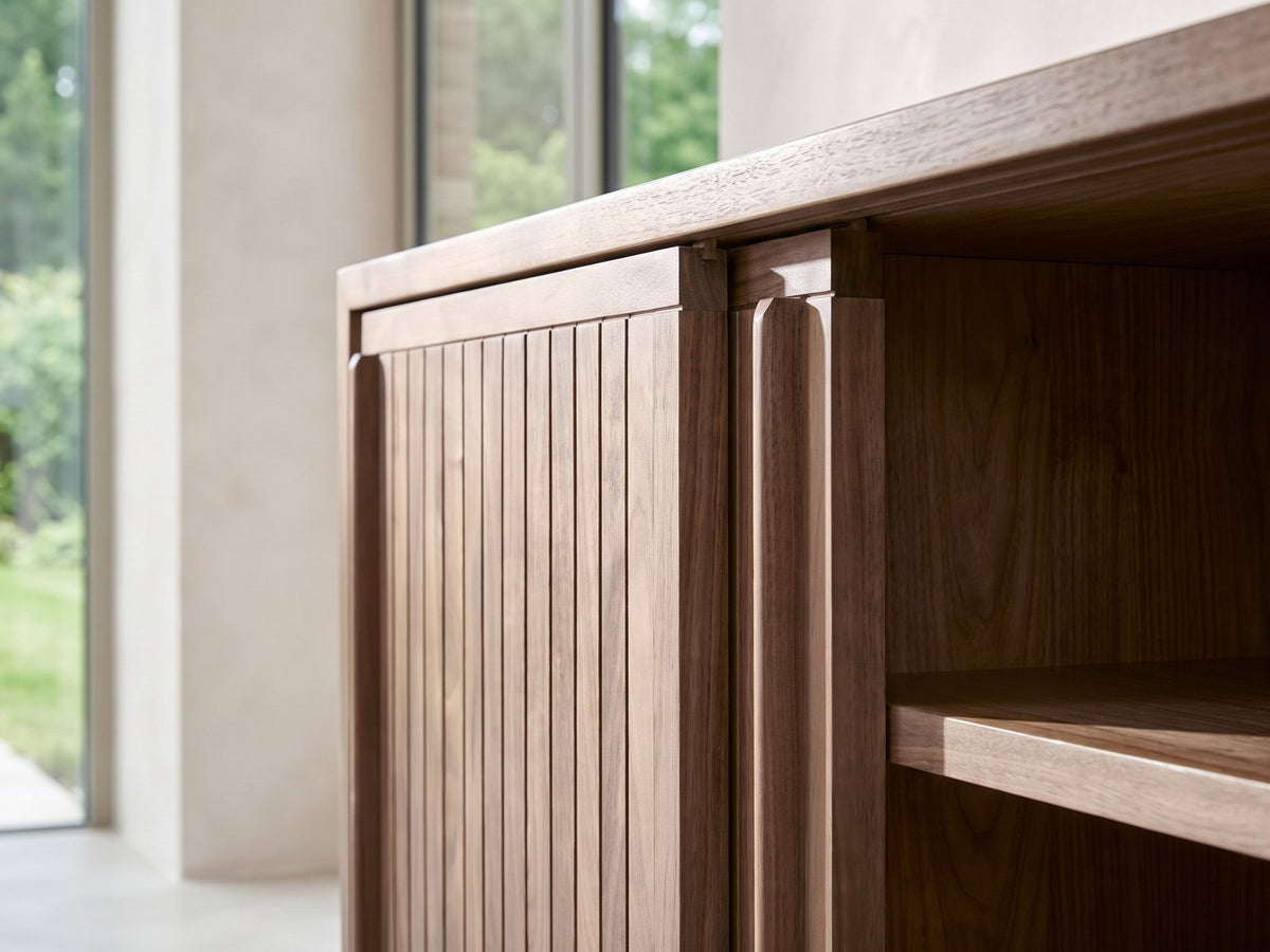 Close-up of the Belluno Solid Walnut Media Cabinet: the slatted walnut sliding doors and the shelf edge behind them
