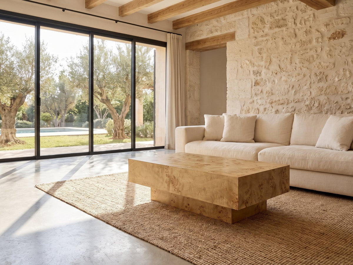 Biella 43-Inch Rectangular Burl Wood Veneer Coffee Table on a jute rug in front of a linen sofa in a poolside villa