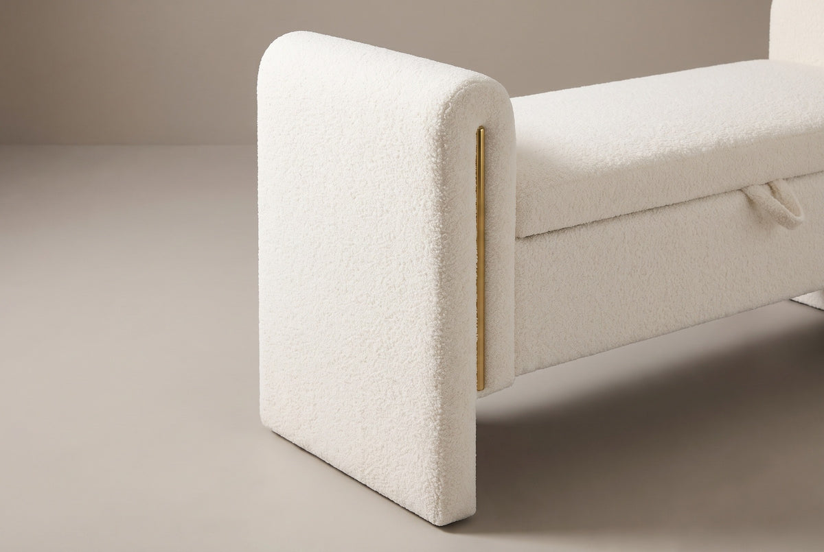 One end of the Bracciano bench: the thick teddy-covered arm with its rounded top and gold-tone strip, standing on the floor beside the floating seat box