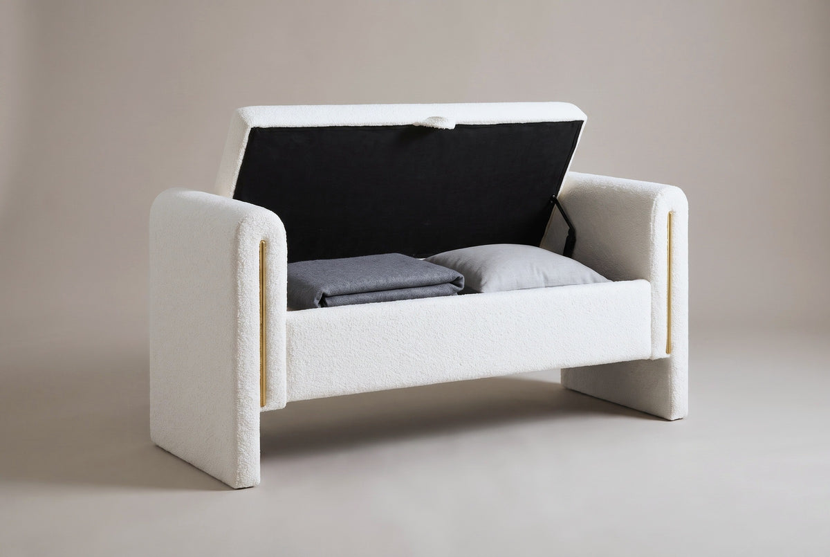 The Bracciano bench with the lid open on a metal support: a black-fabric-lined compartment holding a folded grey blanket and a grey cushion