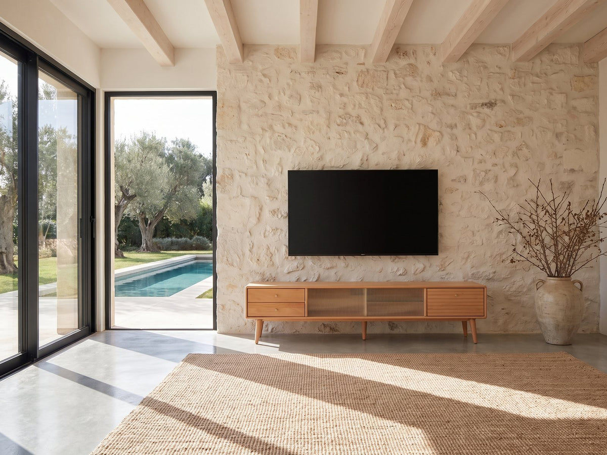 Bressanone Solid Beech Media Console under a wall-mounted screen on a pale stone wall in a poolside villa