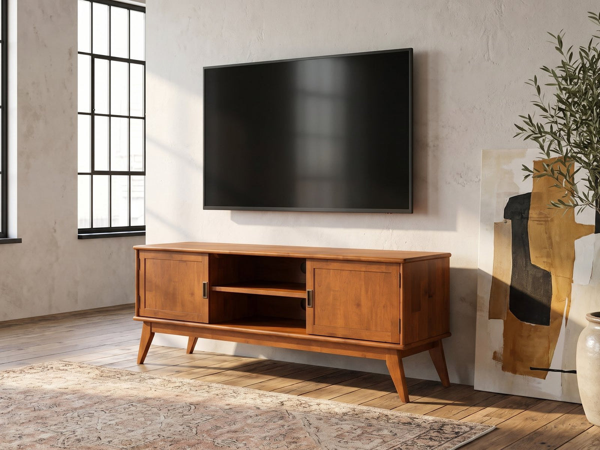 Brisighella Mid-Century Media Console seen from the side, under a wall-mounted screen in an industrial loft