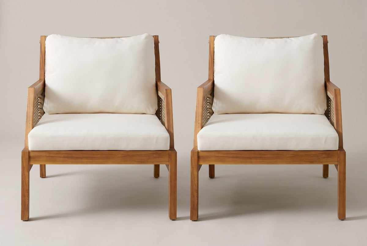 The two Buccheri club chairs seen from the front: square acacia legs, a flat acacia seat frame, ivory seat cushions and tall back cushions