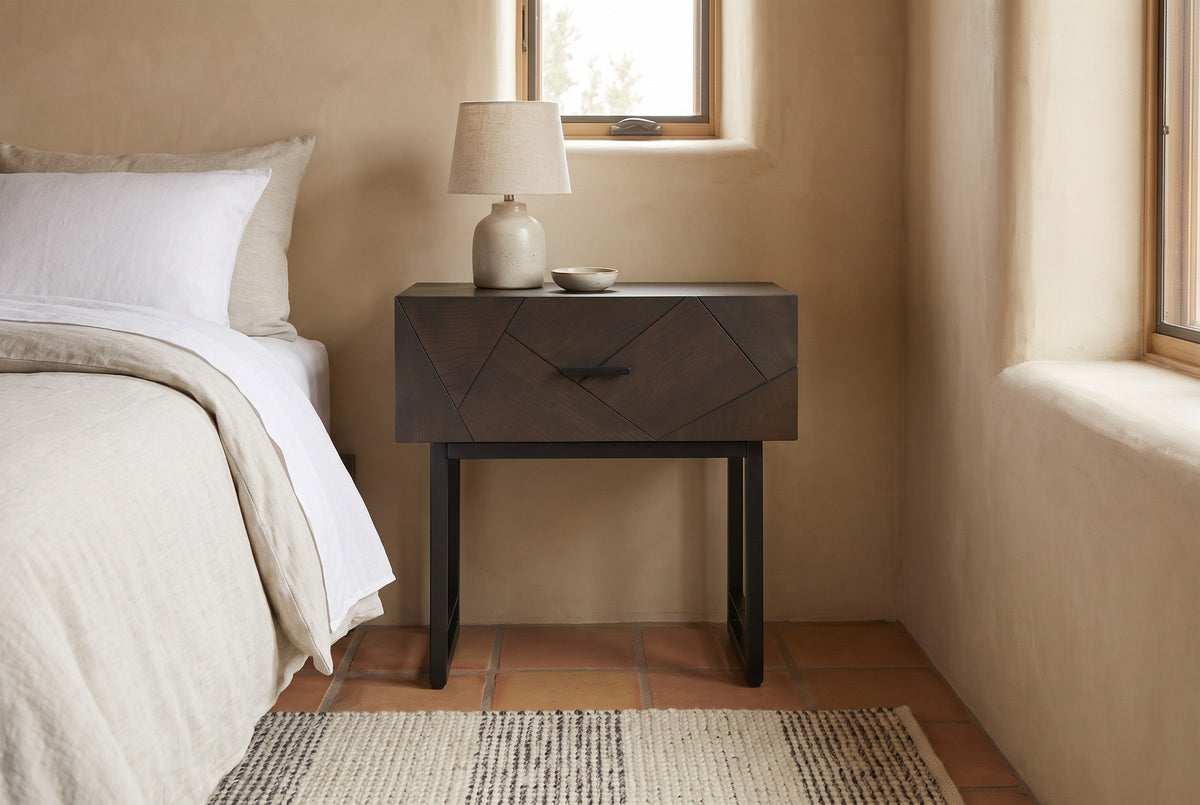 Budoni smoked oak nightstand against a sand-coloured lime plaster wall in a Santa Fe bedroom with a terracotta tile floor and a wool rug
