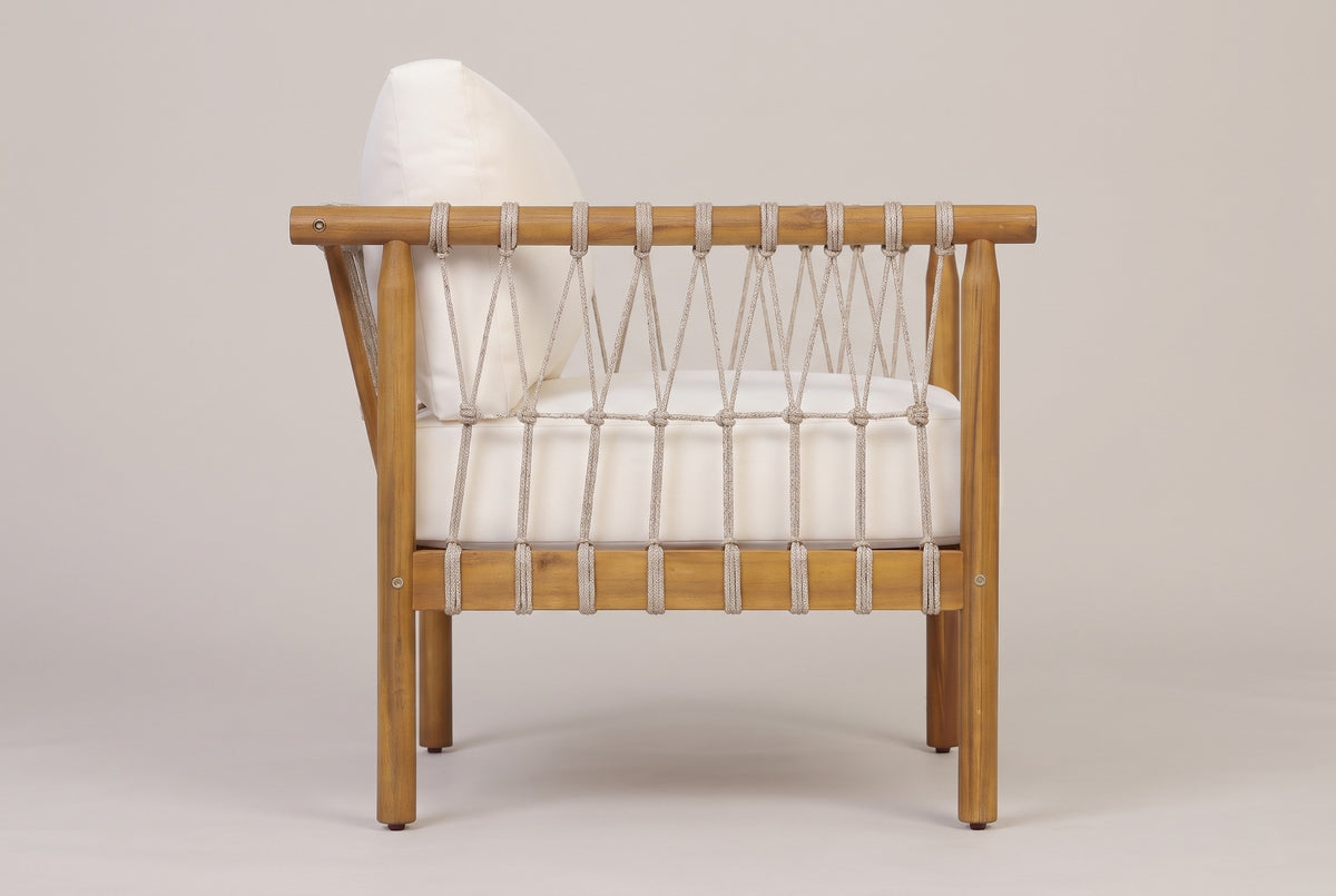 The Burgio club armchair seen from the side: the round arm rail, the criss-cross rope lacing with one row of knots and the rope-wrapped lower rail