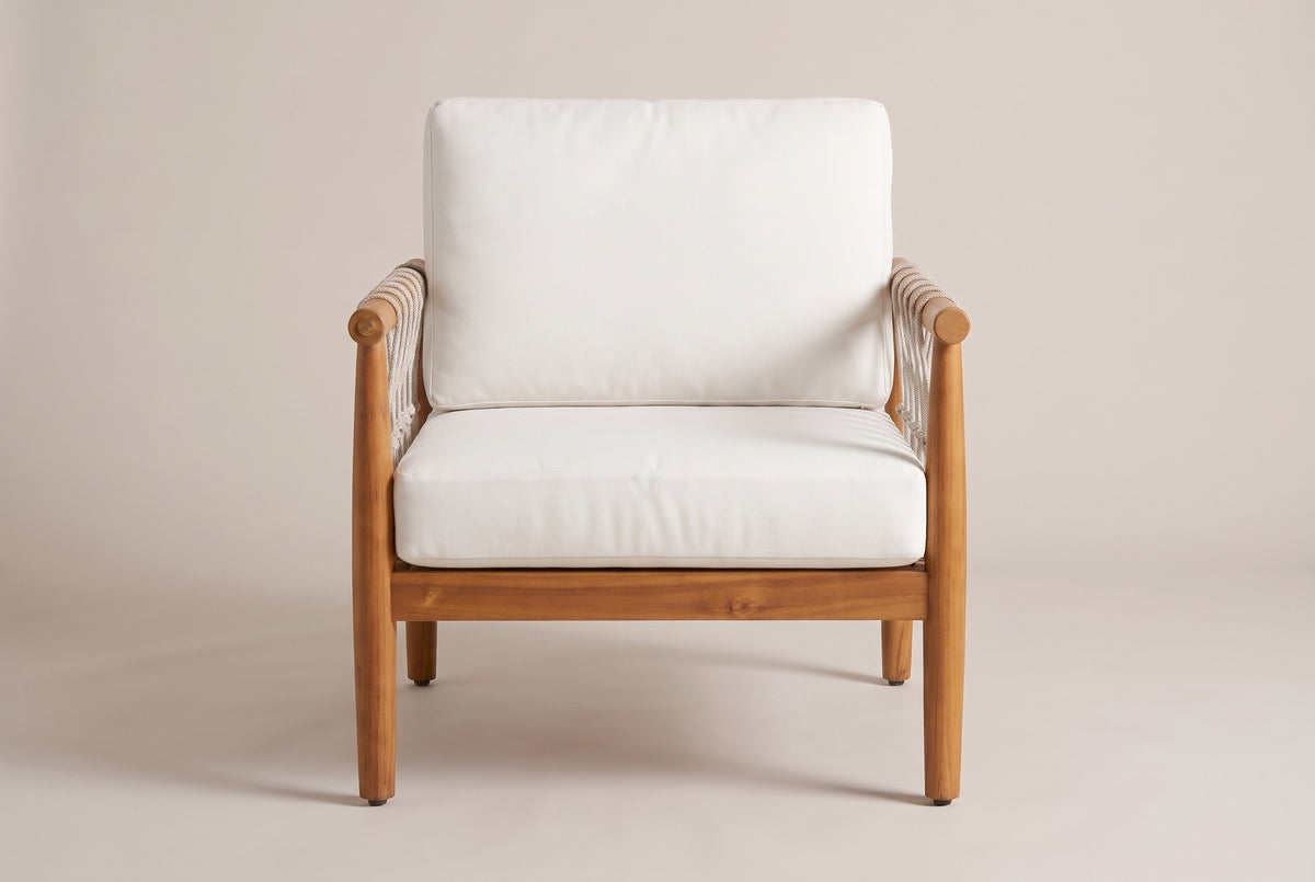The Burgio club armchair seen from the front: the cream back cushion and seat cushion between two round acacia arms on round legs