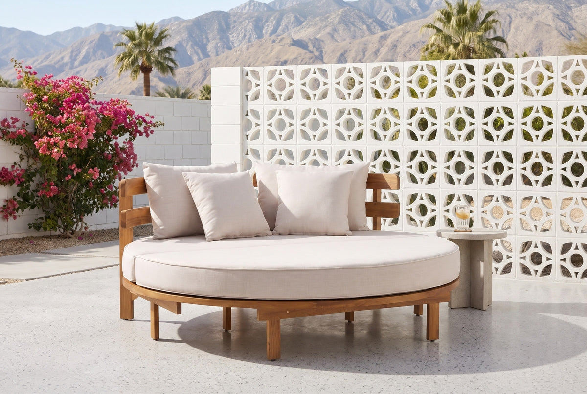 Butera round daybed on a terrazzo patio in Palm Springs, a white breeze-block wall and the mountains behind (side table not included)