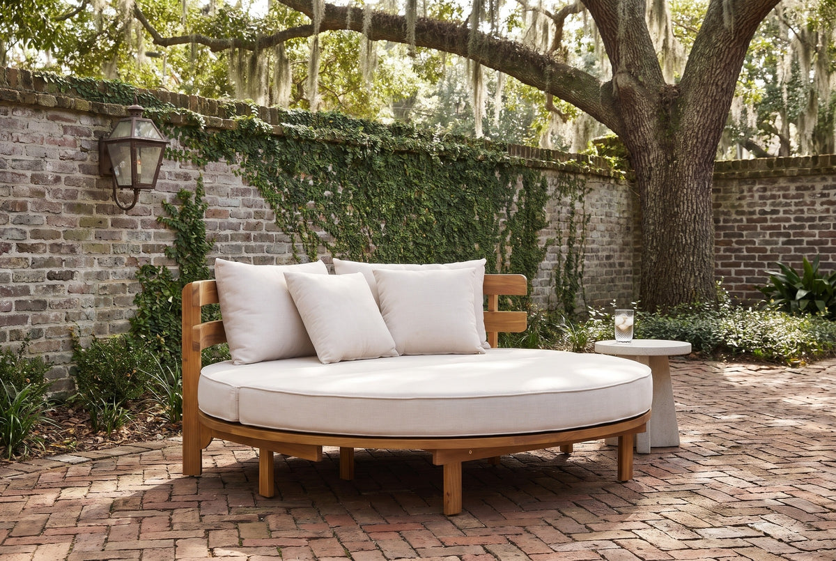 Butera round daybed in a Savannah walled courtyard with an old grey brick wall, a herringbone brick floor and a live oak (side table not included)