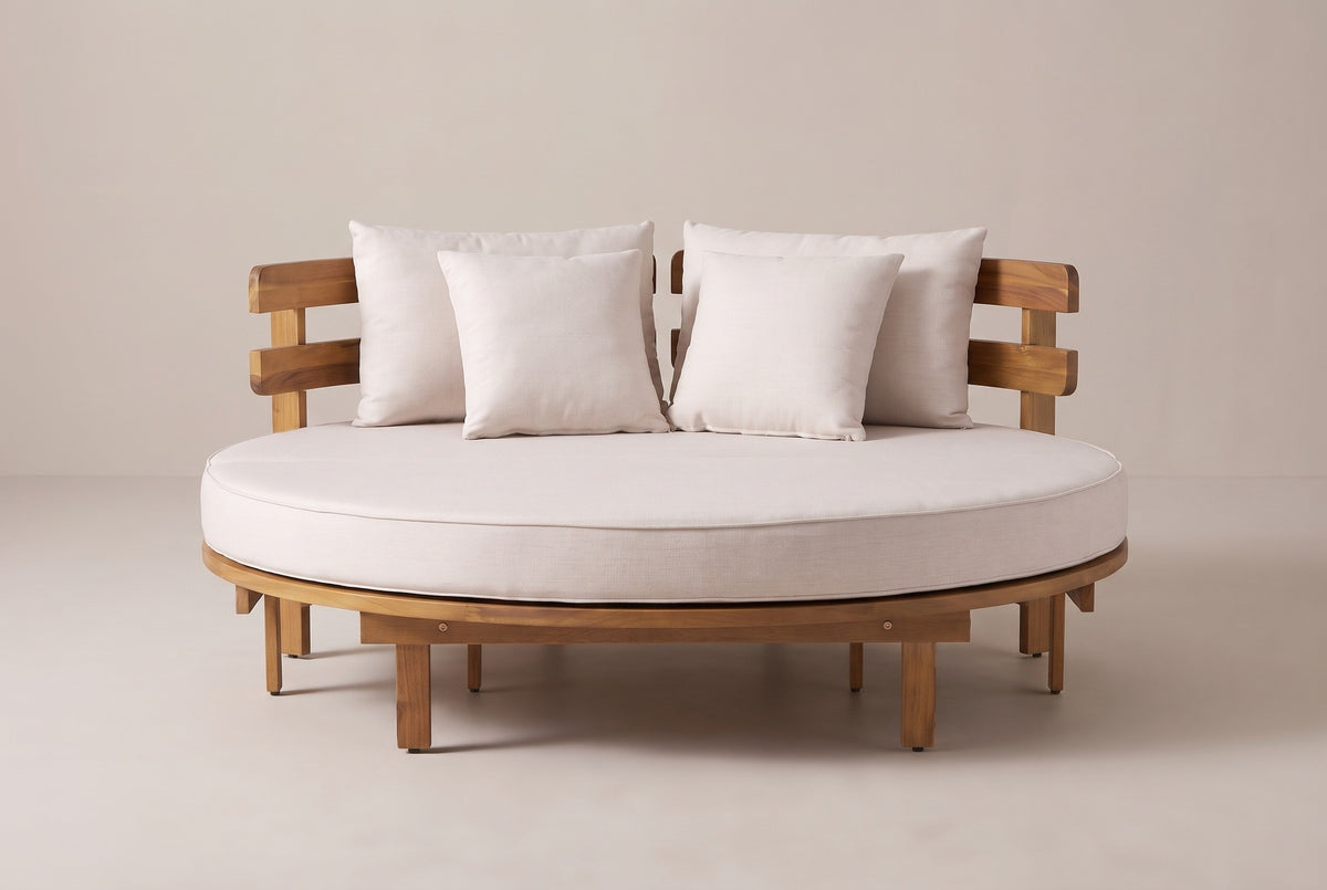 The Butera round daybed seen from the front: the round cushion, four pillows and both curved backrest sections