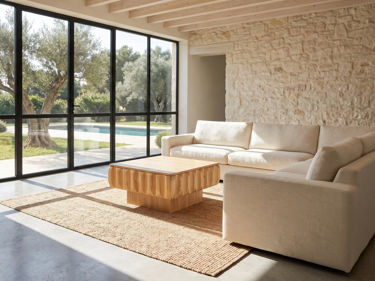 Canelli 31-Inch Square Scalloped Ash Veneer Lift-Top Coffee Table on a jute rug in front of a linen sofa in a poolside villa