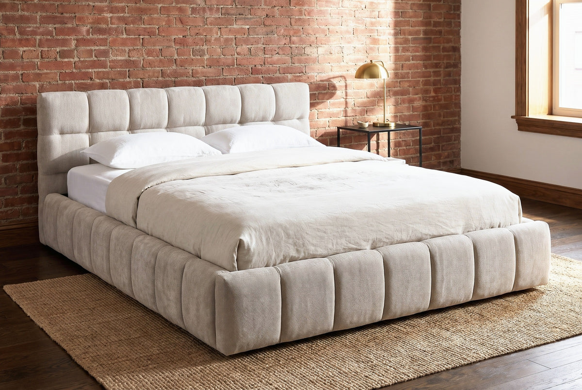 Capracotta floor bed against an exposed red brick wall in a Brooklyn brownstone bedroom with a dark oak floor and a jute rug