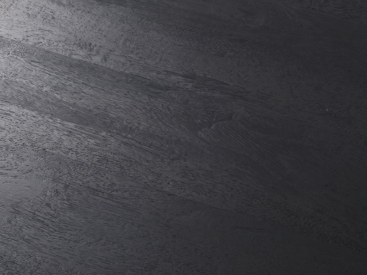 Close-up of the Caramanico Black Mango Tapered Drum Side Table: the black-finished mango grain of the top