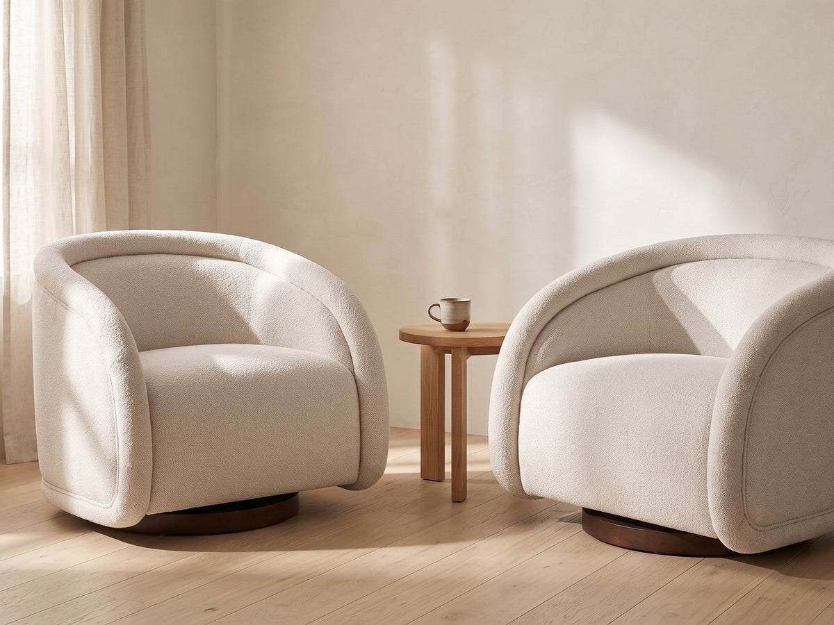Two Carina swivel chairs facing each other with a small table between them