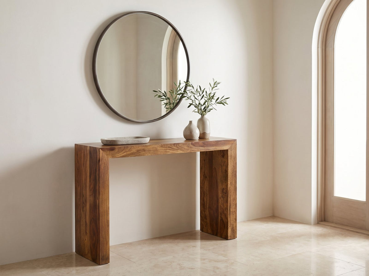 Carosino Solid Sheesham Waterfall Console Table under a round mirror in a travertine entryway