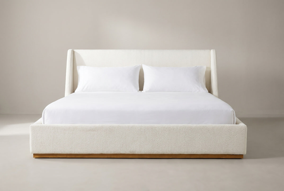 Casoli white boucle winged bed with a white mattress and pillows (not included), front view