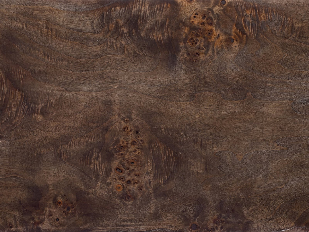 Close-up of the Castellana Burl Veneer Waterfall Console Table: the dark poplar burl veneer of the top
