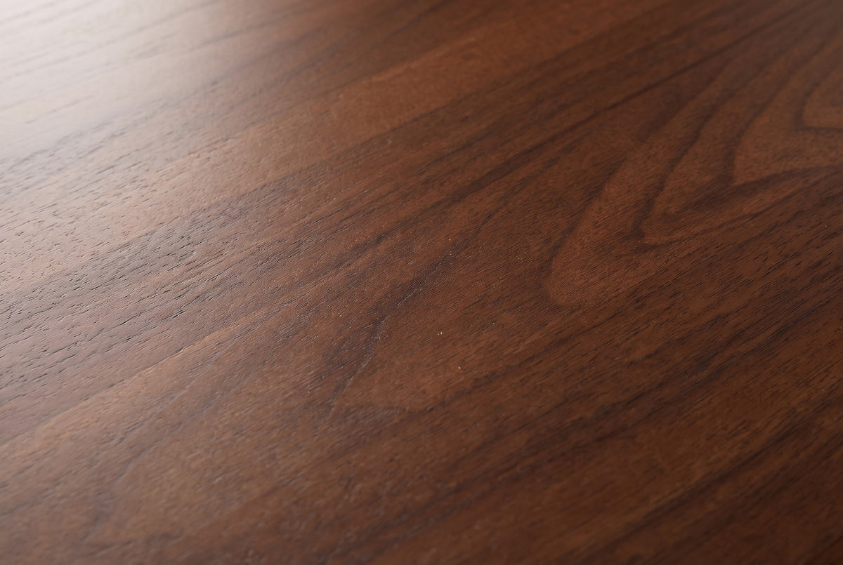 Close-up of the Castelsardo nightstand: dark walnut veneer with an arched figure and fine open pores