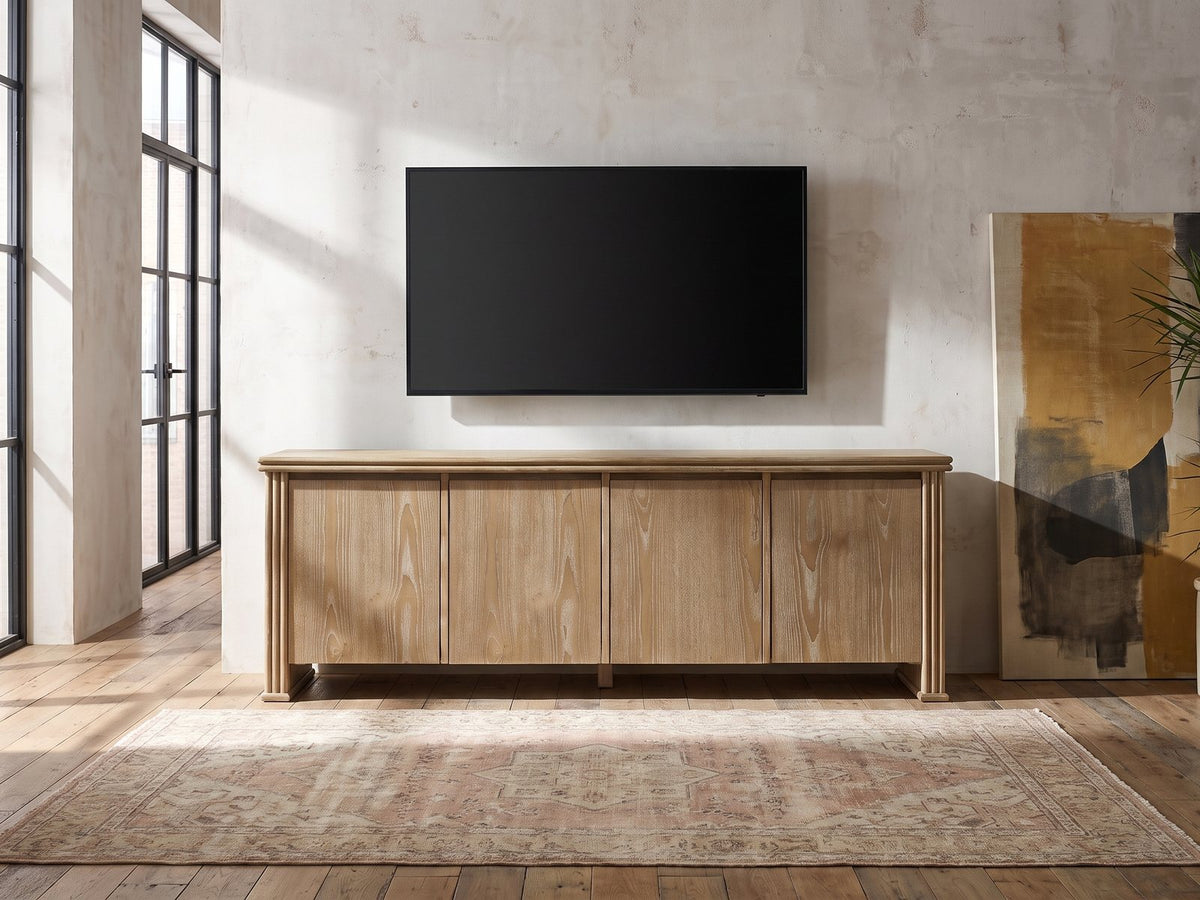 Cefalu Fluted Oak Media Console under a wall-mounted screen in an industrial loft