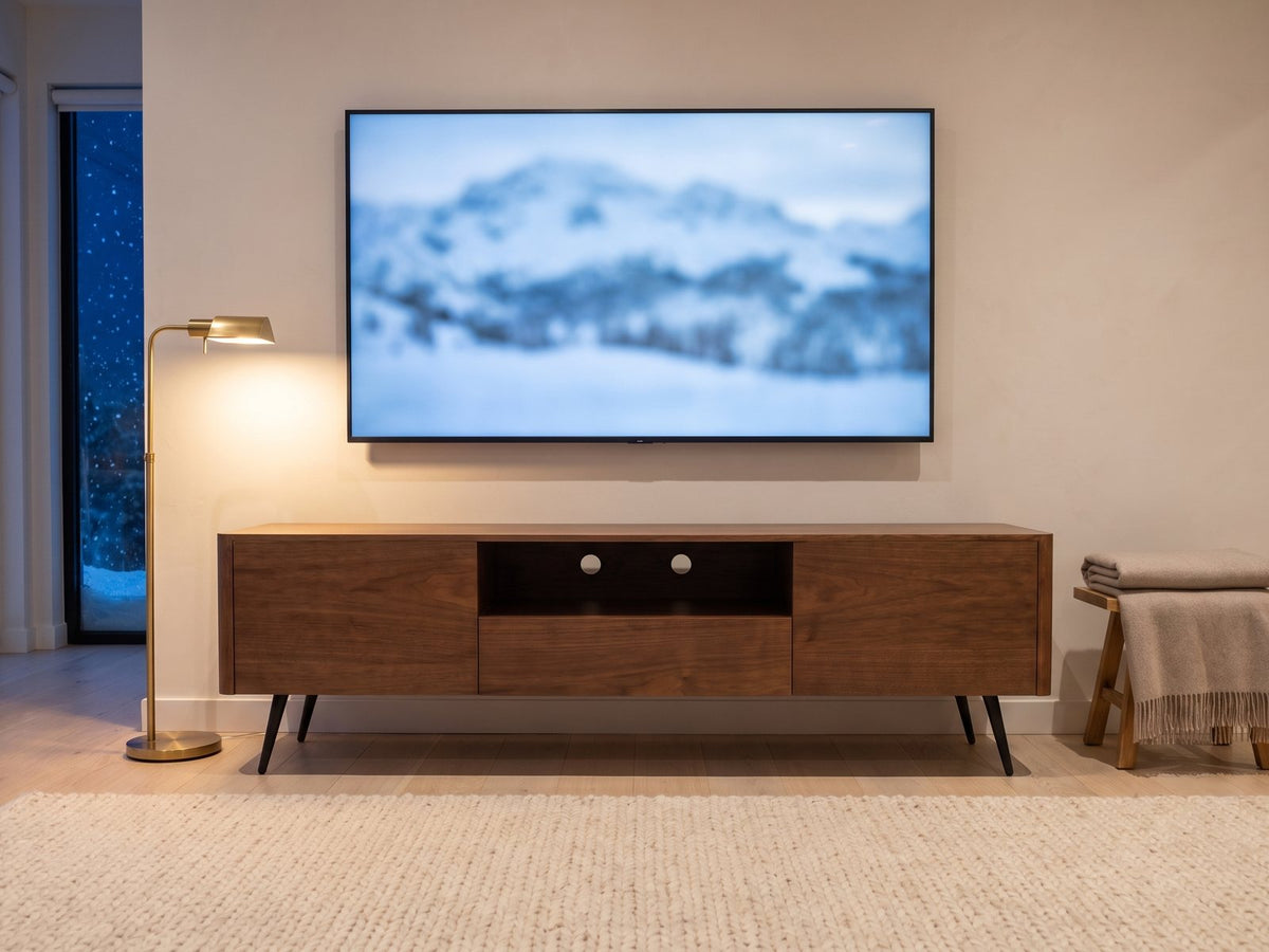 Cernobbio Curved Walnut Media Console under a screen showing a snowy landscape on a winter evening