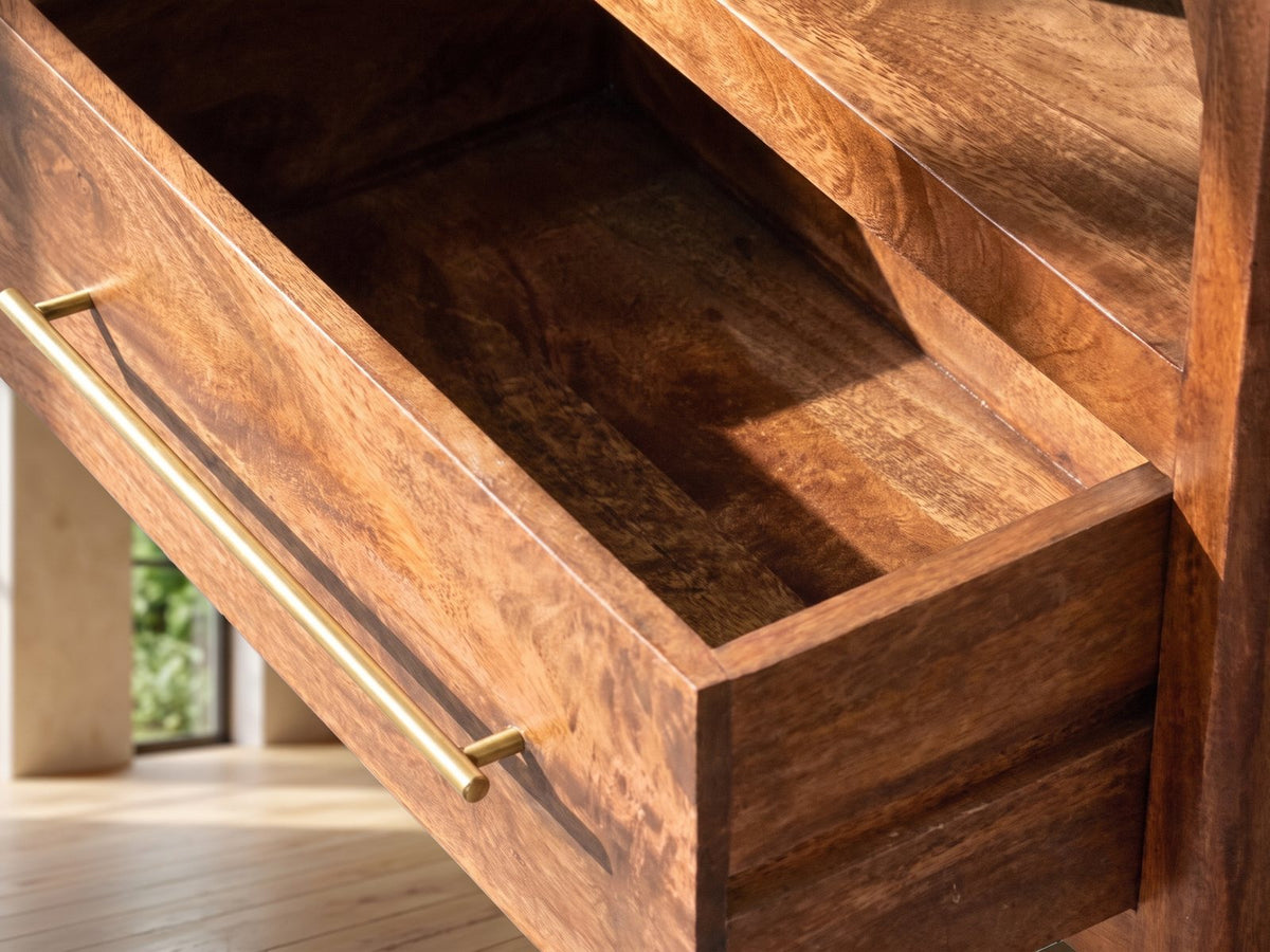 Close-up of the Cherasco Arch Mango Media Console: an open mango drawer with its slim brass bar pull