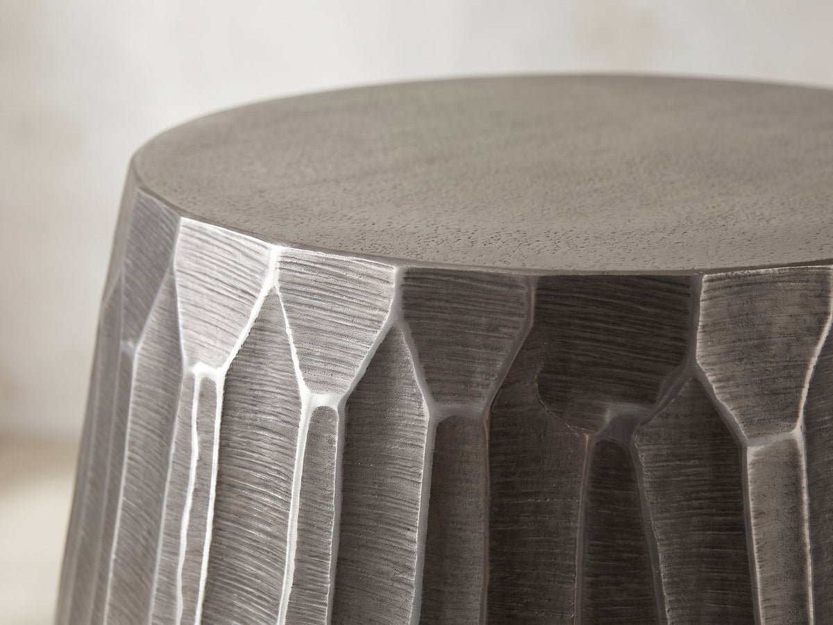 Close-up of the Chianciano Cast Aluminum Faceted Drum Side Table: the flat cast top meeting the faceted wall at the rim