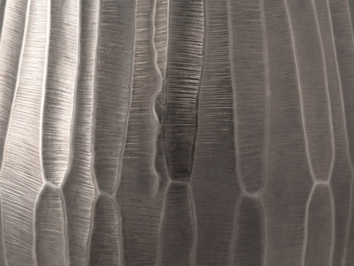 Close-up of the Chianciano Cast Aluminum Faceted Drum Side Table: the faceted graphite cast aluminum wall