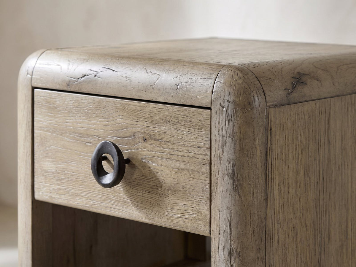 Close-up of the Chiaromonte Knotty Oak Veneer Two-Drawer Side Table: the rounded corner, top drawer and sculpted ring pull
