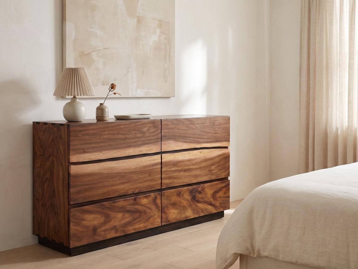 Chioggia 64-Inch Smokey Walnut 6-Drawer Dresser against a plaster wall under an abstract canvas in a bright bedroom