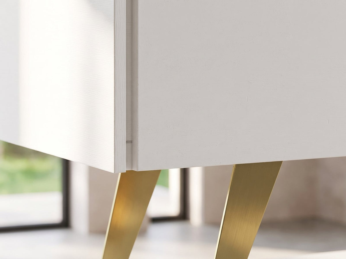Close-up of the Cittadella White Media Console: the angled brass-gold sled leg under the white cabinet